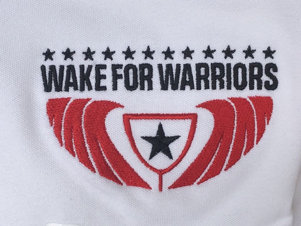 Close-up of an embroidered logo in red, white and navy thread