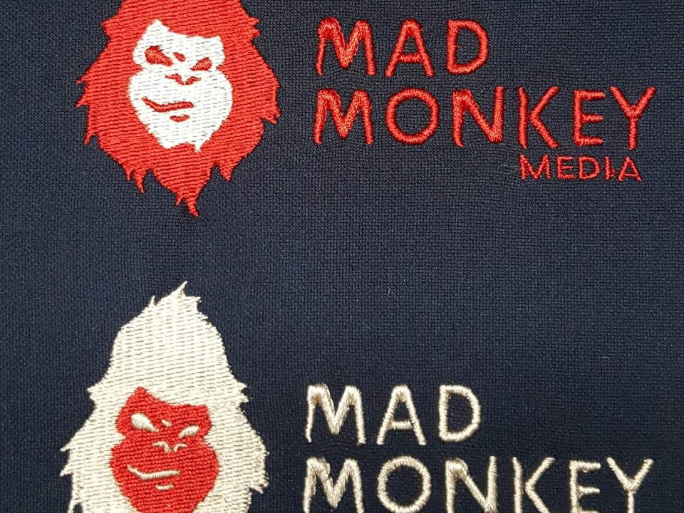 MAD Monkey Media logo embroidered in red and white thread
